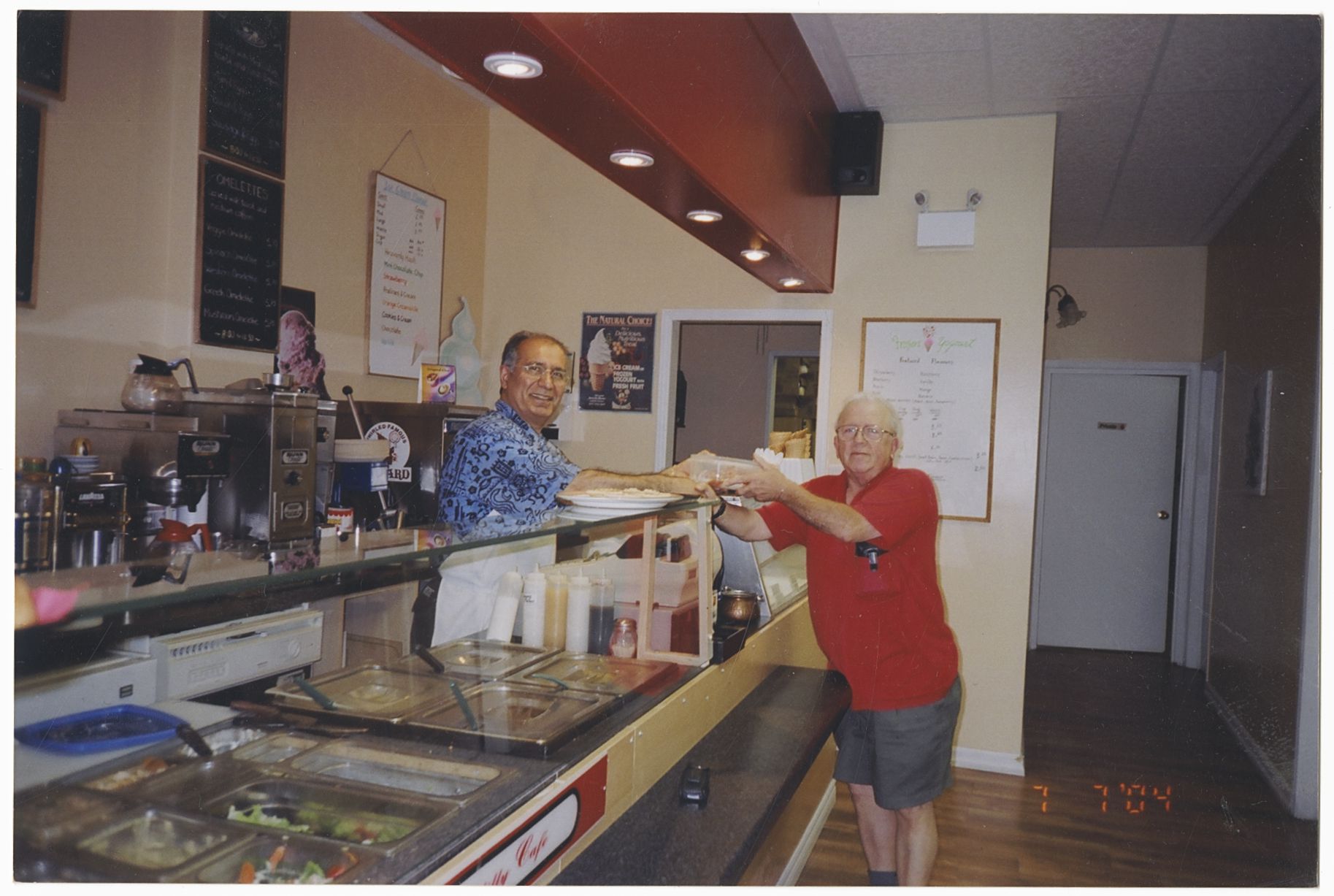 photo of the restaurant owner an a customer